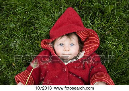 Stock Image - A baby with a dandelion. Fotosearch