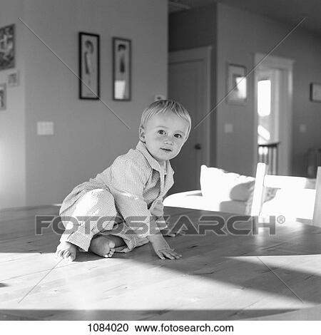 A boy sitting on a table in his pajamas View Large Photo Image Stock Image - A boy sitting on a table in his pajamas. Fotosearch
