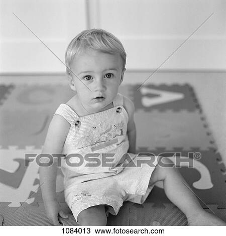A boy sitting on an alphabet jigsaw puzzle mat View Large Photo Image Stock Image - A boy sitting on an alphabet jigsaw puzzle mat. Fotosearch