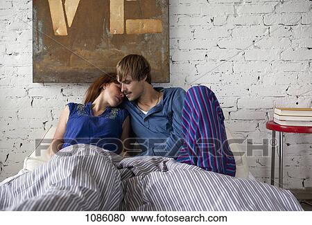 Stock Image - A couple lying in bed, sensual. Fotosearch