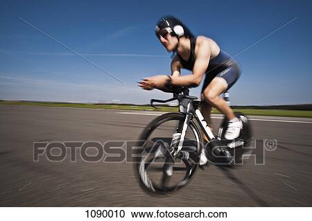 A cyclist on a racing bicycle, side view View Large Photo Image Stock Image - A cyclist on a racing bicycle, side view. Fotosearch