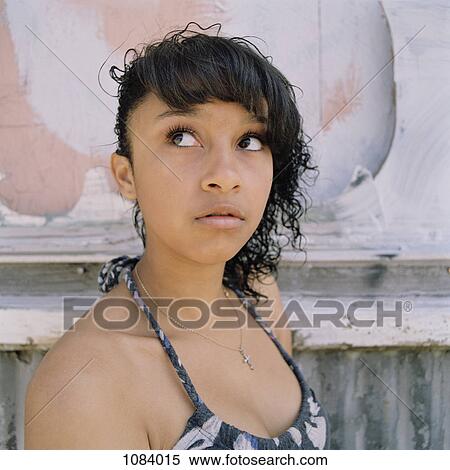 A fashionable teenage girl looking up curiously View Large Photo Image Stock Photography - A fashionable teenage girl looking up curiously. Fotosearch