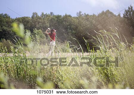 A female golfer teeing off View Large Photo Image Stock Image - A female golfer teeing off. Fotosearch