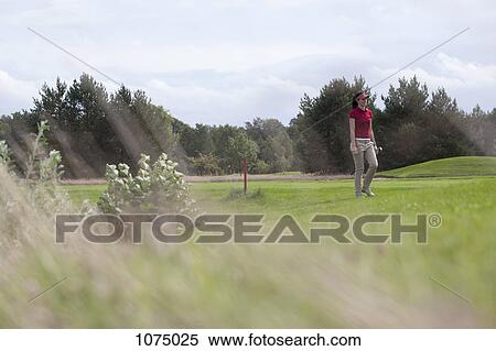 A female golfer walking on a golf course View Large Photo Image Stock Photography - A female golfer walking on a golf course. Fotosearch