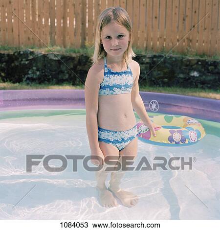 Stock Image - **A girl in a wading pool. Fotosearch