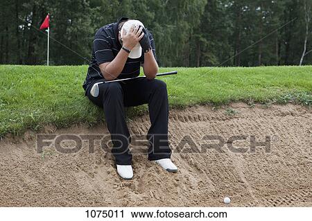 A golfer sitting at the edge of sand trap, head in hands View Large Photo Image Stock Image - A golfer sitting at the edge of sand trap, head in hands. Fotosearch