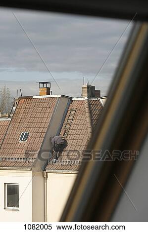 Stock Photography - A man repairing a roof. Fotosearch