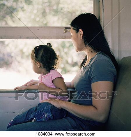 A mother and daughter on a train, looking through window View Large Photo Image Picture - A mother and daughter on a train, looking through window. Fotosearch