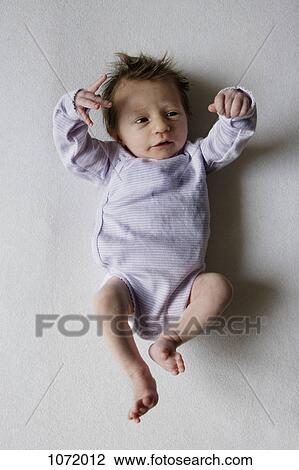 Stock Image - A newborn looking at her hand . Fotosearch
