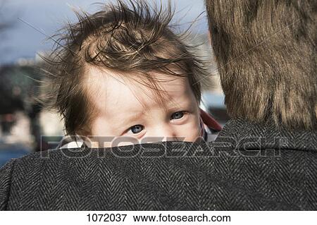 A newborn looking over her father's shoulder, over the shoulder view View Large Photo Image Stock Photo - A newborn looking over her father's shoulder, over the shoulder view. Fotosearch
