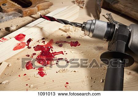 Stock Image - A power drill with blood on it. Fotosearch