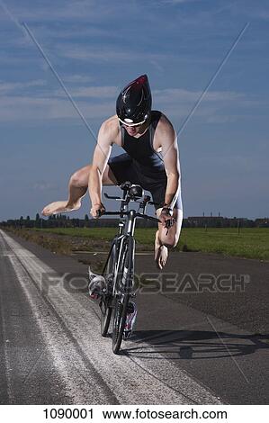 A racing cyclist performing a stunt View Large Photo Image Stock Image - A racing cyclist performing a stunt. Fotosearch