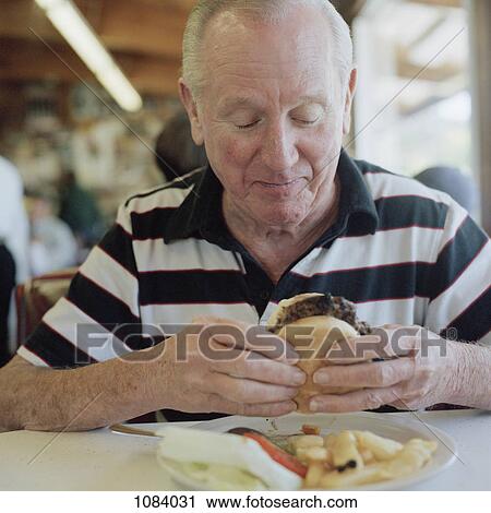A senior man getting ready to eat a hamburger View Large Photo Image Stock Image - A senior man getting ready to eat a hamburger. Fotosearch