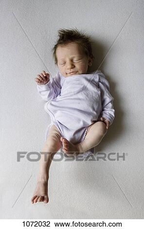 A sleeping newborn View Large Photo Image Stock Image - A sleeping newborn. Fotosearch