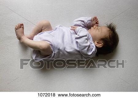 A sleeping newborn View Large Photo Image Stock Photo - A sleeping newborn. Fotosearch