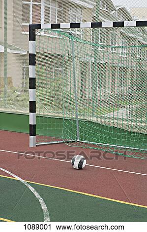 Stock Image - A soccer ball near a soccer goal. Fotosearch