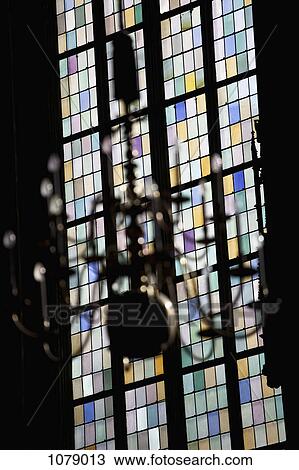 A stained glass window in back of a chandelier, focus on window View Large Photo Image Stock Image - A stained glass window in back of a chandelier, focus on window. Fotosearch