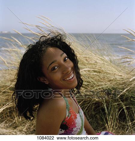 A teenage girl enjoying a day at the beach View Large Photo Image Stock Image - A teenage girl enjoying a day at the beach. Fotosearch