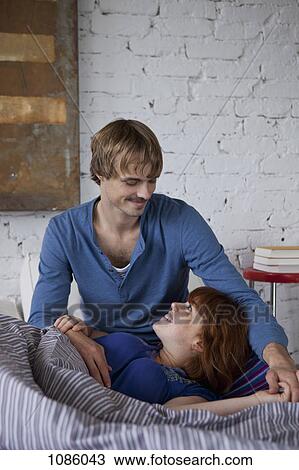 A woman with her head resting in her boyfriend's lap View Large Photo Image Stock Image - A woman with her head resting in her boyfriend's lap. Fotosearch