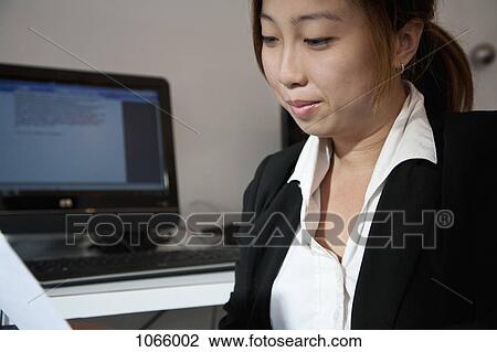 A woman working in an office View Large Photo Image Stock Image - A woman working in an office. Fotosearch