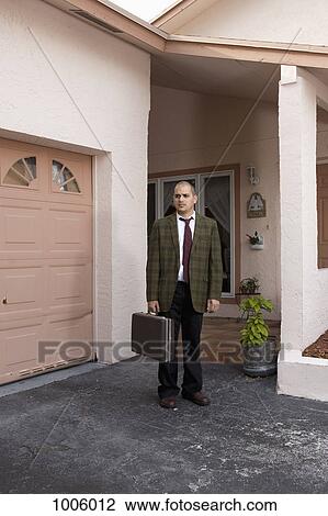 A worried looking businessman standing in his driveway View Large Photo Image Stock Image - A worried looking businessman standing in his driveway. Fotosearch