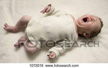 A yawning newborn View Large Photo Image Stock Photograph - A yawning newborn. Fotosearch