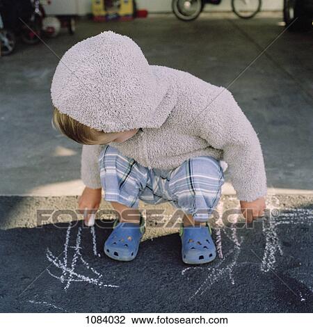 A young boy scribbling on the sidewalk with chalk View Large Photo Image Stock Image - A young boy scribbling on the sidewalk with chalk. Fotosearch