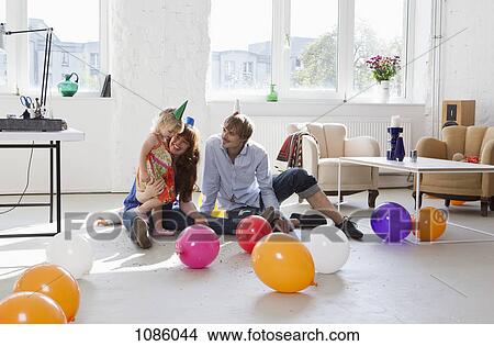 A young family celebrating their daughter's birthday View Large Photo Image Picture - A young family celebrating their daughter's birthday. Fotosearch