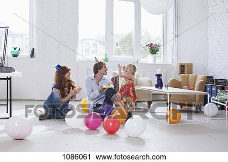A young family celebrating their daughter's birthday View Large Photo Image Stock Image - A young family celebrating their daughter's birthday. Fotosearch