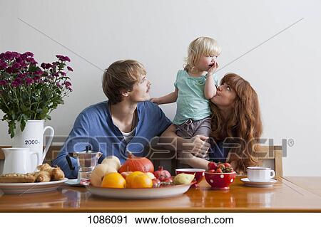 A young family having breakfast View Large Photo Image Stock Image - A young family having breakfast. Fotosearch