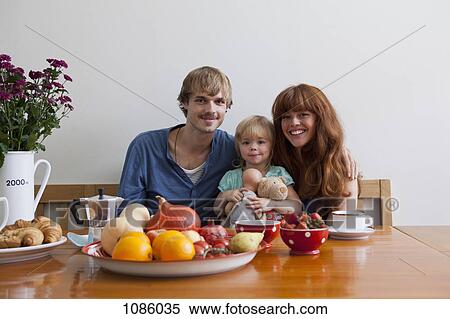 A young family having breakfast View Large Photo Image Stock Photography - A young family having breakfast. Fotosearch