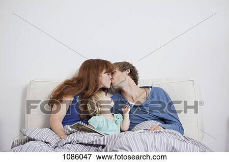 A young family in bed in the morning View Large Photo Image Stock Photo - A young family in bed in the morning. Fotosearch