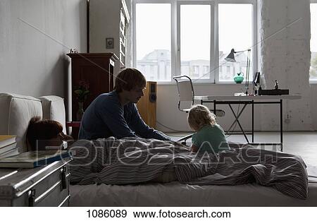 A young family in bed View Large Photo Image Stock Photo - A young family in bed. Fotosearch