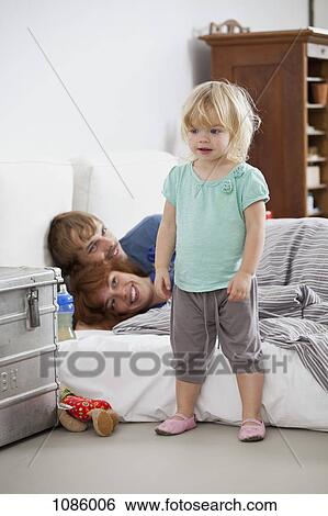 A young girl standing front of her parents' bed View Large Photo Image Stock Photograph - A young girl standing front of her parents' bed. Fotosearch