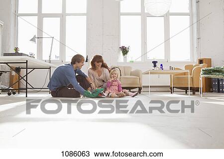 A young hip family playing together on living room floor View Large Photo Image Stock Image - A young hip family playing together on living room floor. Fotosearch