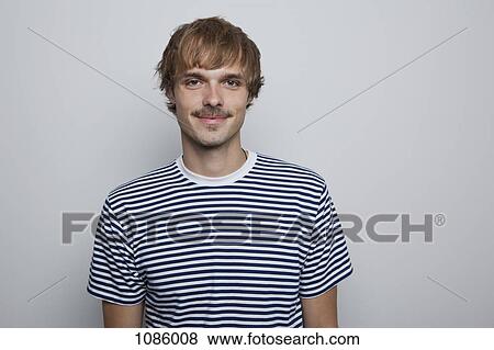 A young, hip man in a striped t-shirt View Large Photo Image Stock Photo - A young, hip man in a striped t-shirt. Fotosearch
