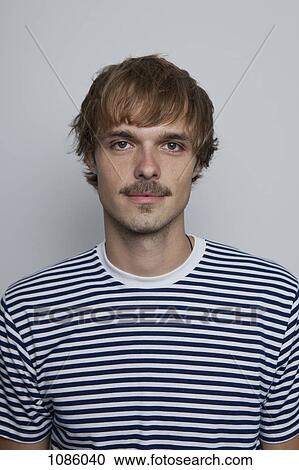 Stock Image - A young man with a mustache wearing a striped t-shirt. Fotosearch