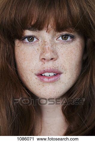Stock Image - A young woman looking sensually into the camera. Fotosearch