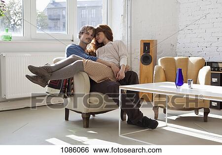 A young woman sitting on her boyfriend's lap View Large Photo Image Stock Photograph - A young woman sitting on her boyfriend's lap. Fotosearch
