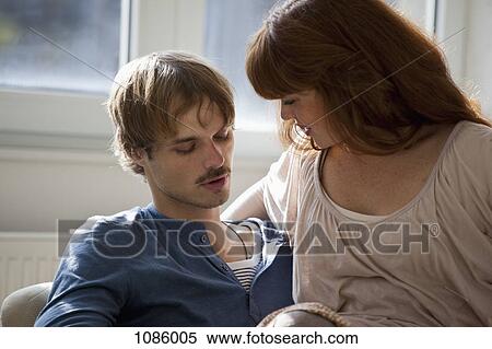 A young woman sitting on her boyfriend's lap View Large Photo Image Stock Photography - A young woman sitting on her boyfriend's lap. Fotosearch