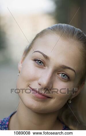 Stock Photo - A young woman with beautiful blue eyes, close-up. Fotosearch