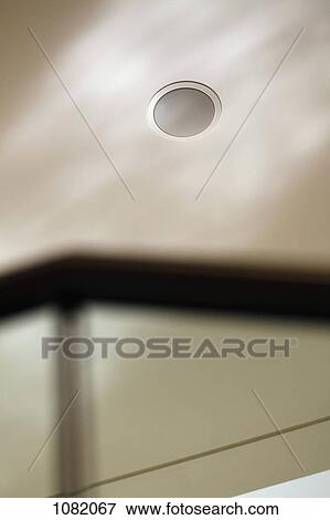 Stock Photo - Air vent against ceiling with defocused glass railings in the foreground. Fotosearch