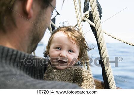 Picture - An excited baby with her father on a boat. Fotosearch