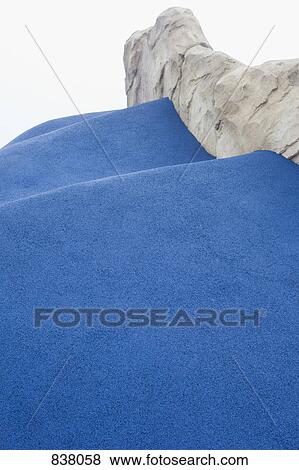 Stock Photo - Artificial water flowing down steps beside artificial rock face. Fotosearch