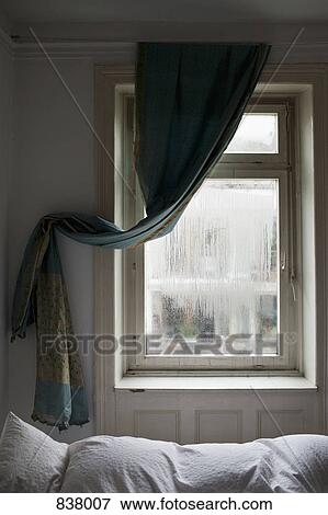 Bedroom showing window and curtain draped to the side View Large Photo Image Stock Photo - Bedroom showing window and curtain draped to the side. Fotosearch