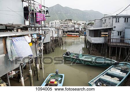 Stock Photography - Boats and elevated houses in Chinese fishing village in Tai O, Hong Kong, China. Fotosearch