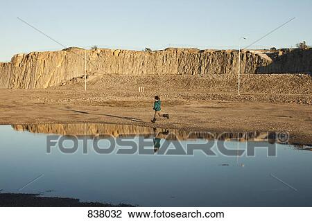 Boy running with reflection in lake View Large Photo Image Stock Image - Boy running with reflection in lake. Fotosearch