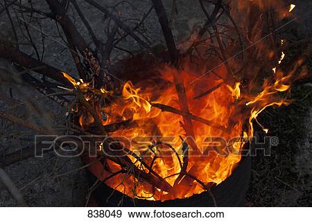 Branches on fire in drum View Large Photo Image Stock Photo - Branches on fire in drum. Fotosearch