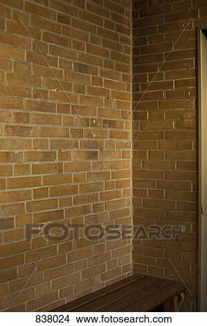 Brick wall and brown bench View Large Photo Image Picture - Brick wall and brown bench. Fotosearch