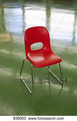 Bright red school chair on green floor View Large Photo Image Stock Image - Bright red school chair on green floor. Fotosearch